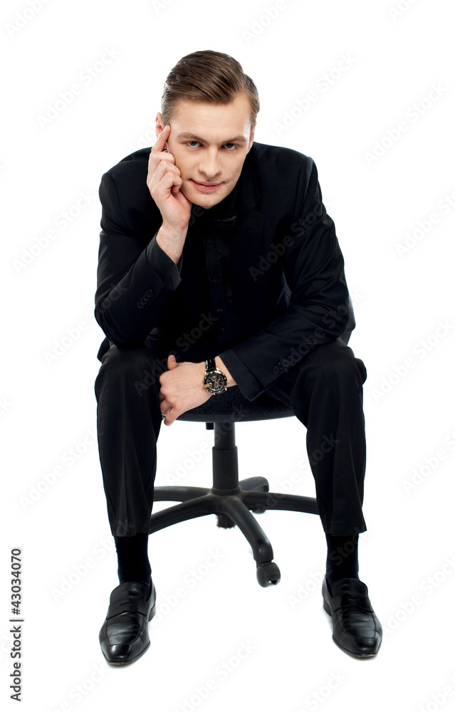 Handsome young caucasian male sitting on chair Handsome young caucasian male sitting on chair
