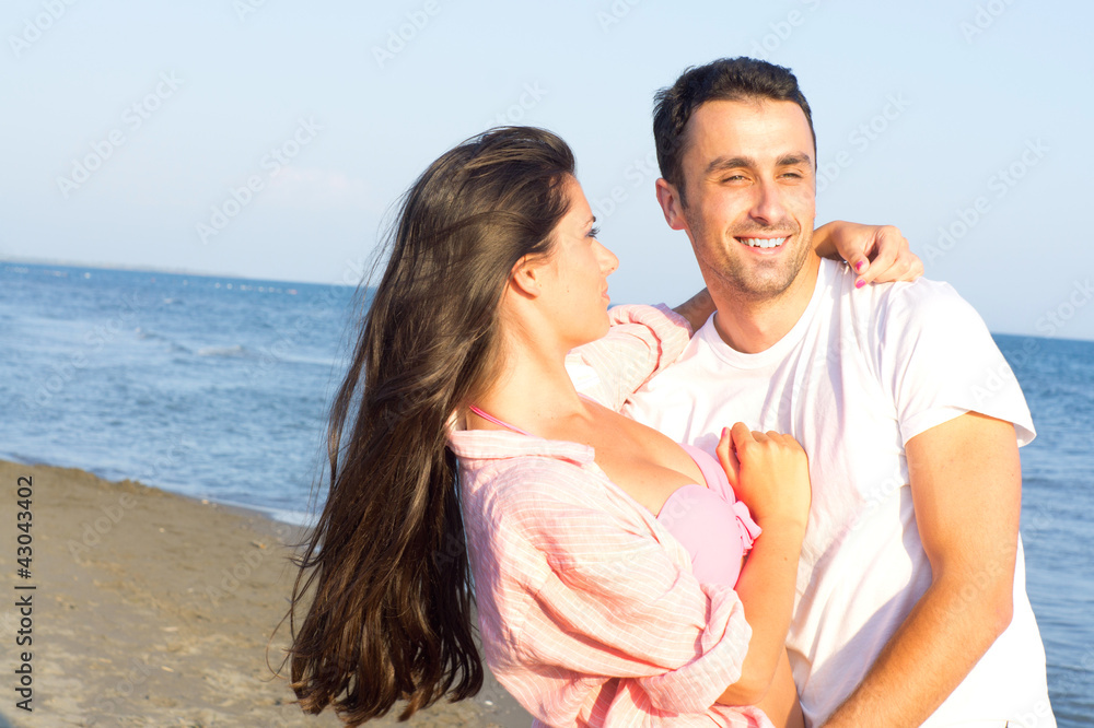 Happy couple at the beach in a playful mood Happy couple at the beach in a playful mood