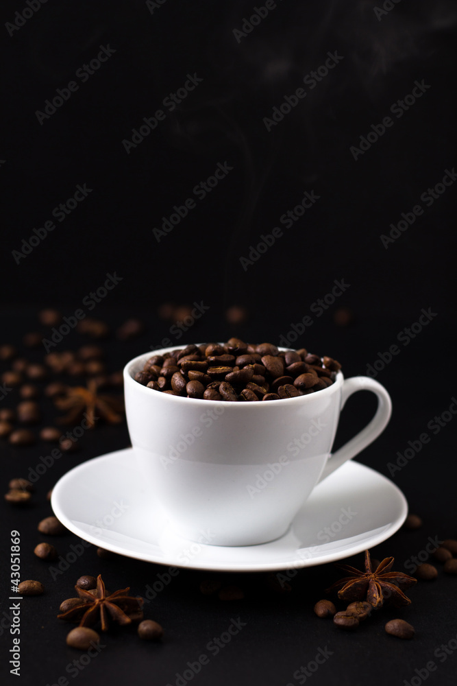 Coffee beans in white cup on black background Coffee beans in white cup on black background