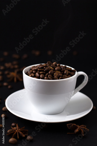 Coffee beans in white cup on black background