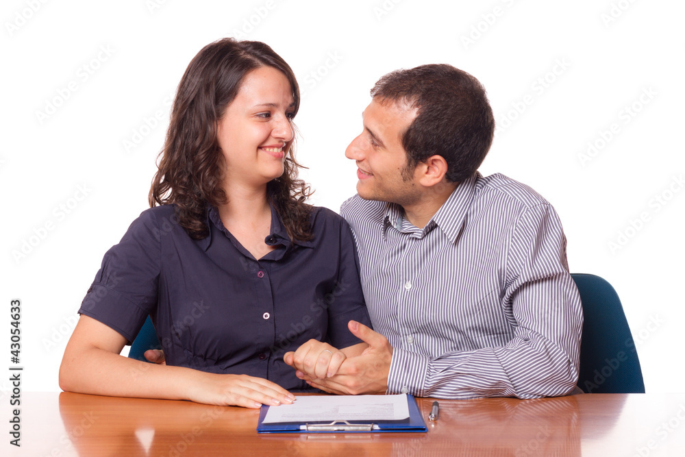 Happy Young Couple with Important Document to Sign Happy Young Couple with Important Document to Sign