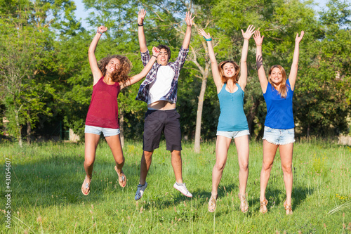 Group of Teenagers Jumping at Park © william87