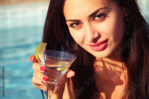 Attractive young girl drinking martini