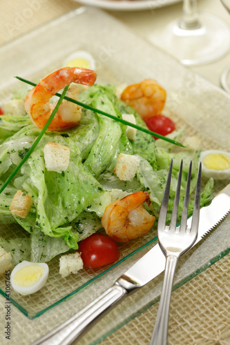 Salad with lettuce leaves, quail eggs and prawns