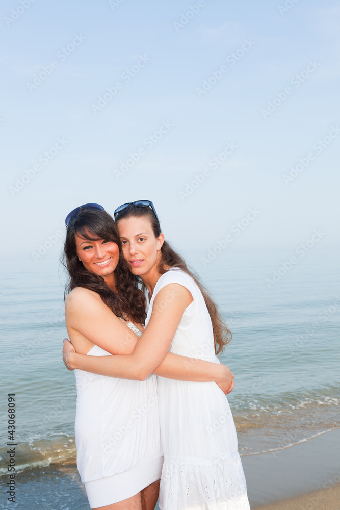 Two Female Friends Embraced on the Beach