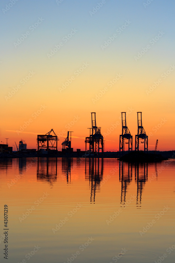 Harbor cranes in early morning dawn
