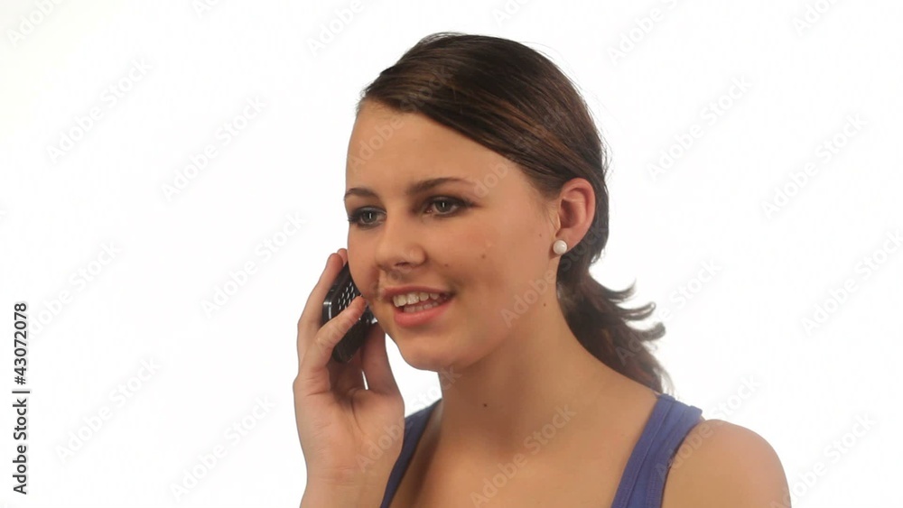 Young girl talking on the phone and smiling isolated Young girl talking on the phone and smiling isolated