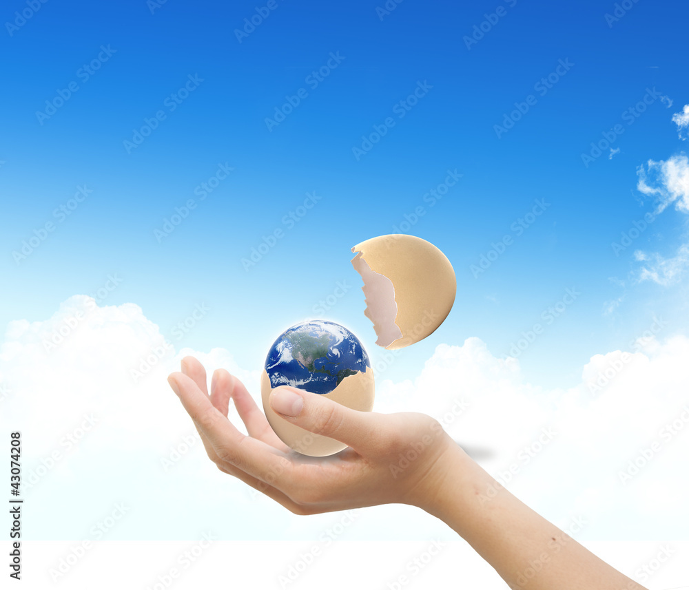 Hand with earth over the blue sky  background embeded on paper t