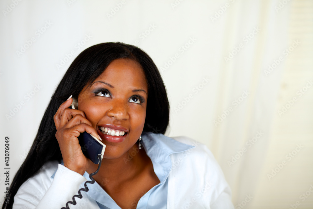 Pretty woman smiling and conversing on phone Pretty woman smiling and conversing on phone