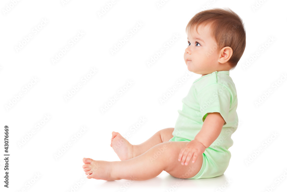 Baby is sitting on floor, isolated on white Baby is sitting on floor, isolated on white