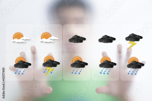 Cuadro en lienzo Man pushing the weather screen on transparent screen