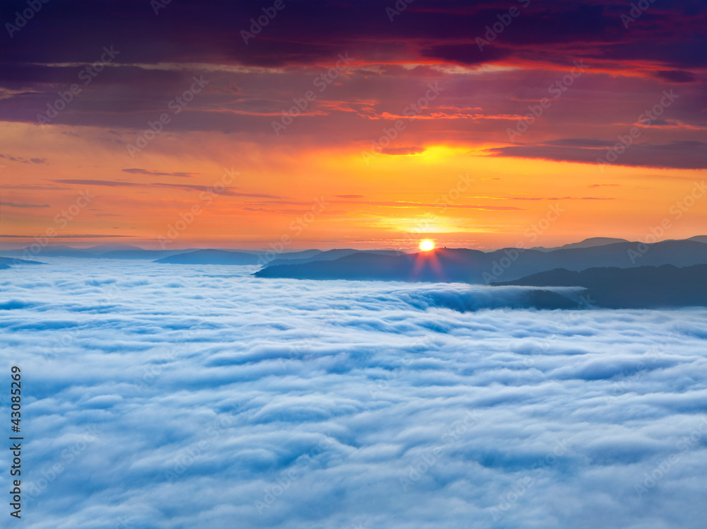 Sunrise over the sea of fog in the mountains at the summer