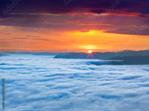 Sunrise over the sea of fog in the mountains at the summer