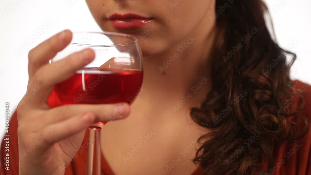 Young woman drinking red wine isolated close Young woman drinking red wine isolated close