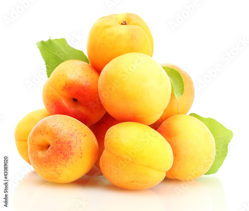 ripe apricots with green leaves isolated on white