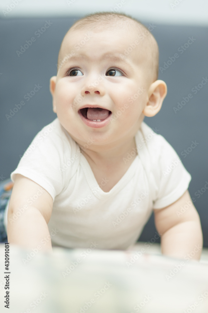 loverly portrait of a baby smiling on a sofa