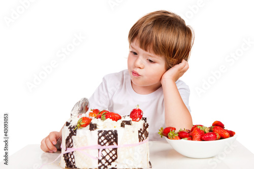 Little boy eating cake with a spoon