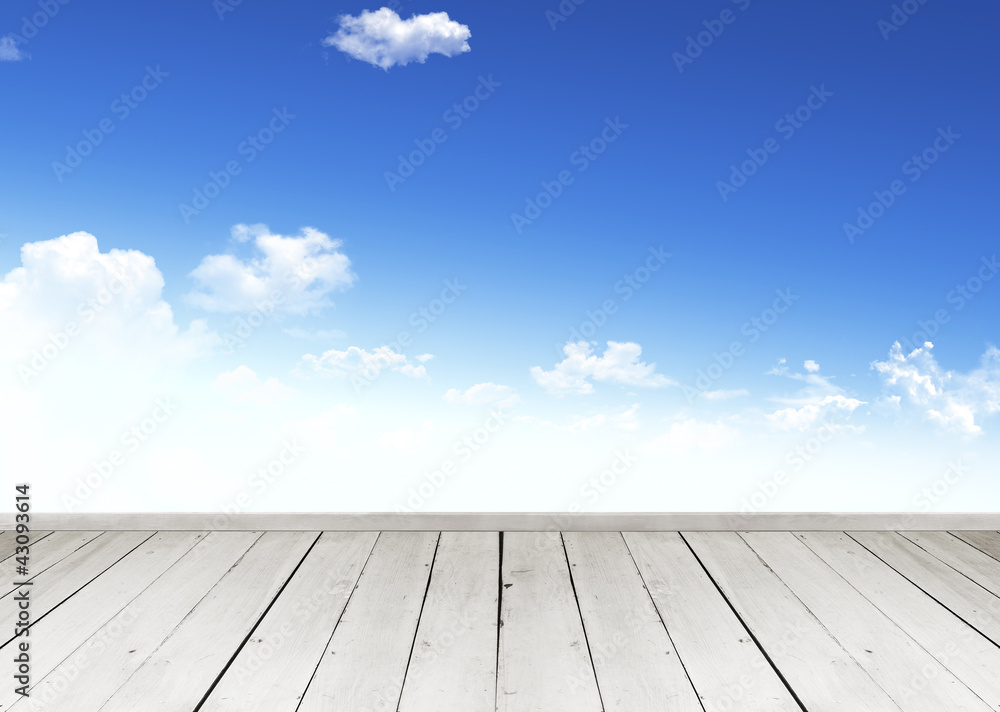 Wooden terrace looking out over a tropical cloud sky