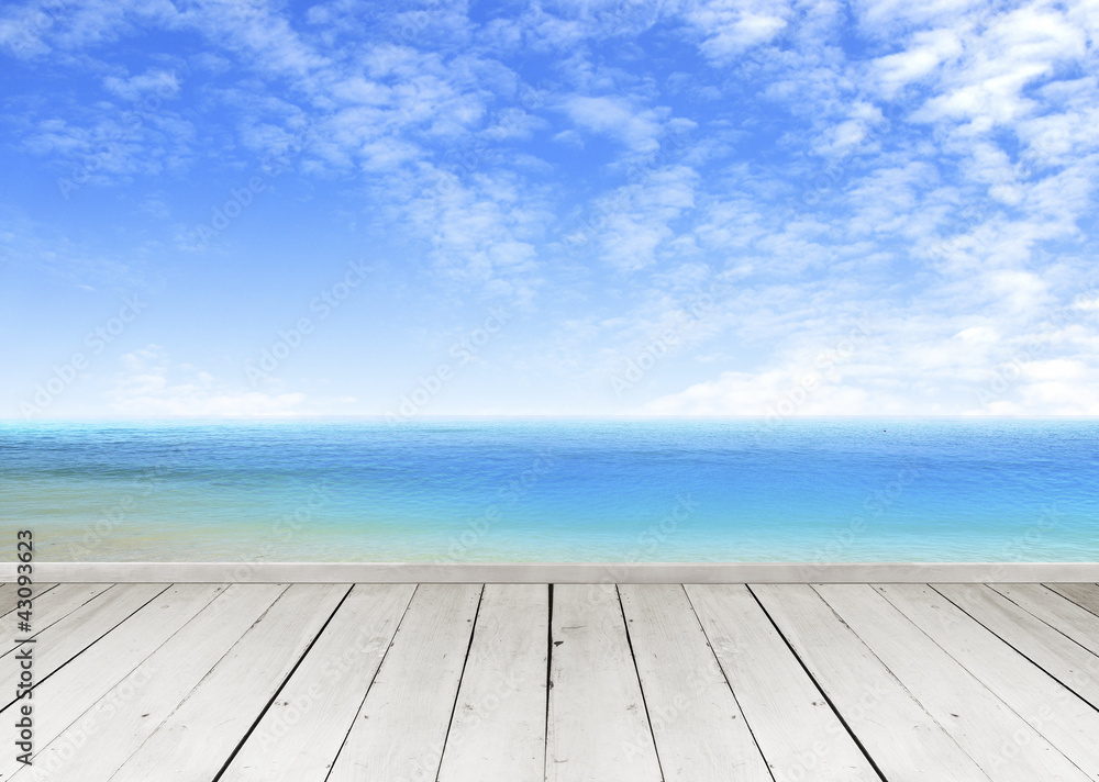 Wooden terrace looking out over a tropical cloud sky and seaview