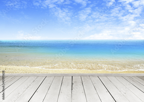 Wooden terrace looking out over a tropical cloud sky and seaview © basketman23