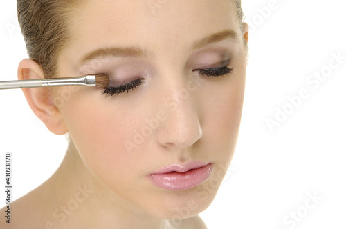 Young woman applying eye shadow