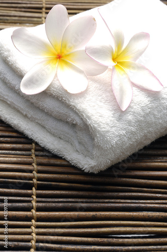 frangipani on towel in the spa