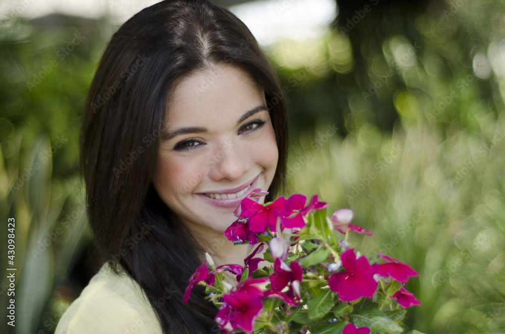 Cute young woman buying flowers at a nursery garden Cute young woman buying flowers at a nursery garden