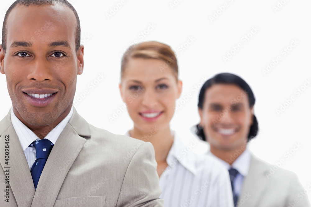Big close-up of workmates in a single line smiling Big close-up of workmates in a single line smiling