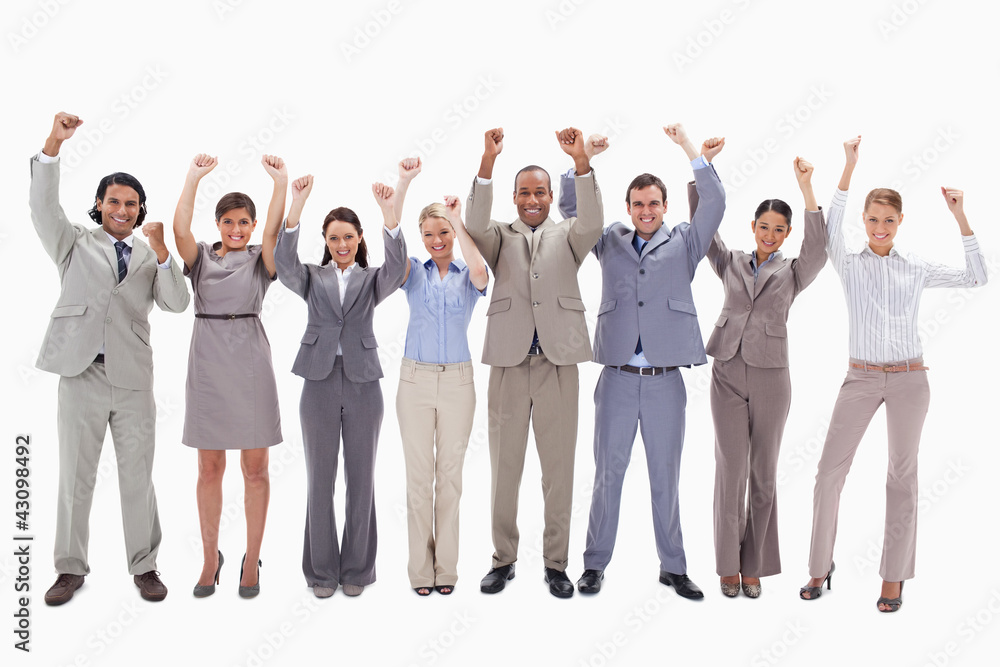 Happy business team raising their arms