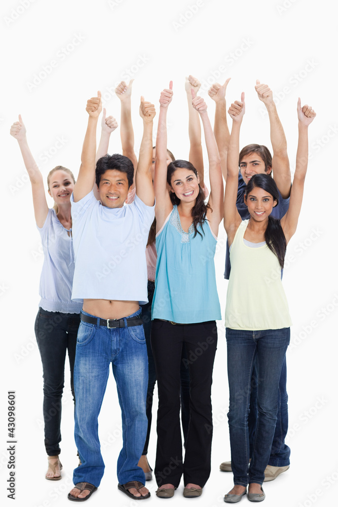 People smiling together raising their arms with their thumbs-up People smiling together raising their arms with their thumbs-up