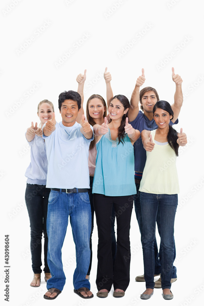 People smiling together and approving with the thumbs-up People smiling together and approving with the thumbs-up