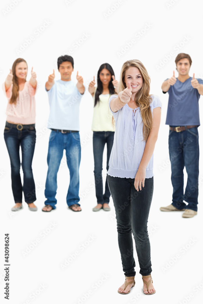 People smiling and approving with one woman in foreground People smiling and approving with one woman in foreground