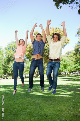 Three students jumping