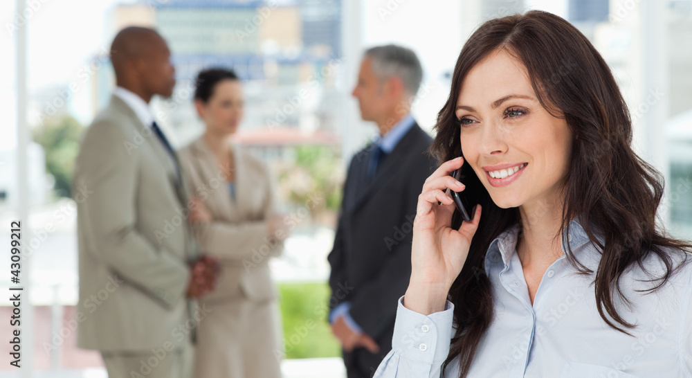 Businesswoman talking on the phone in a relaxed way with her tea Businesswoman talking on the phone in a relaxed way with her tea