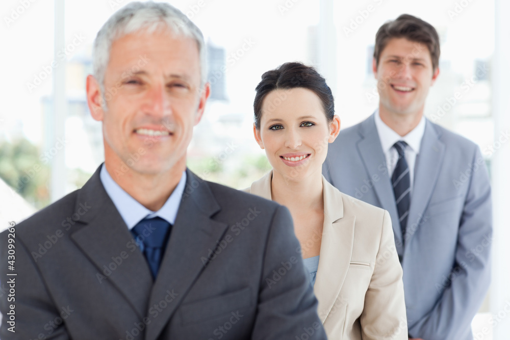 Young smiling executive woman wearing a formal suit between two Young smiling executive woman wearing a formal suit between two