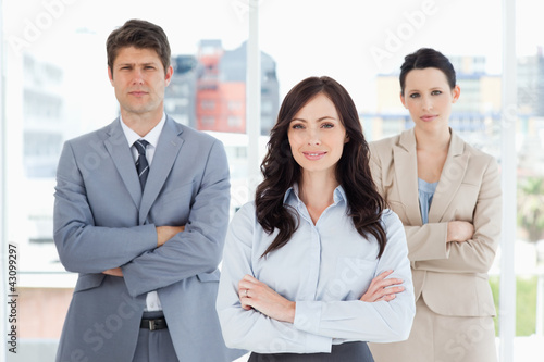 Wallpaper Mural Three business people crossing their arms in front of a bright w Torontodigital.ca