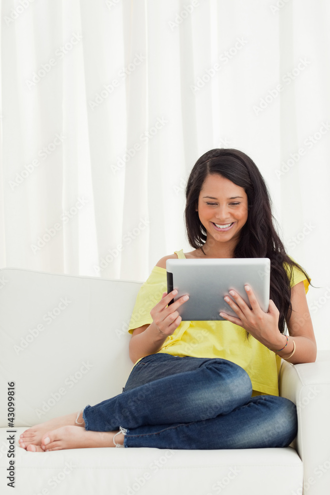 Beautiful smiling Latino looking a touch pad Beautiful smiling Latino looking a touch pad
