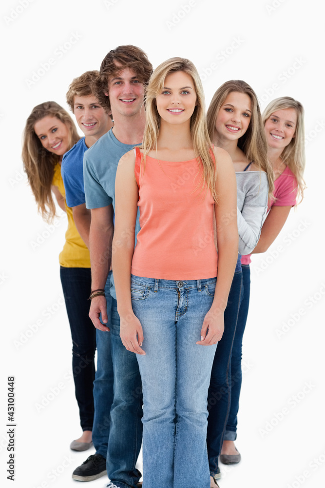 Full length shot of a smiling group standing behind one another Full length shot of a smiling group standing behind one another