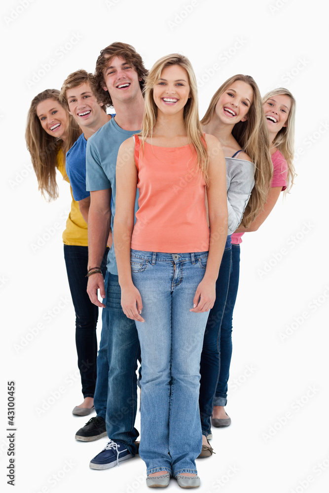 A smiling group of people standing and looking at the camera A smiling group of people standing and looking at the camera