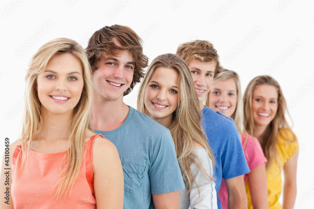 A smiling group standing behind each other A smiling group standing behind each other