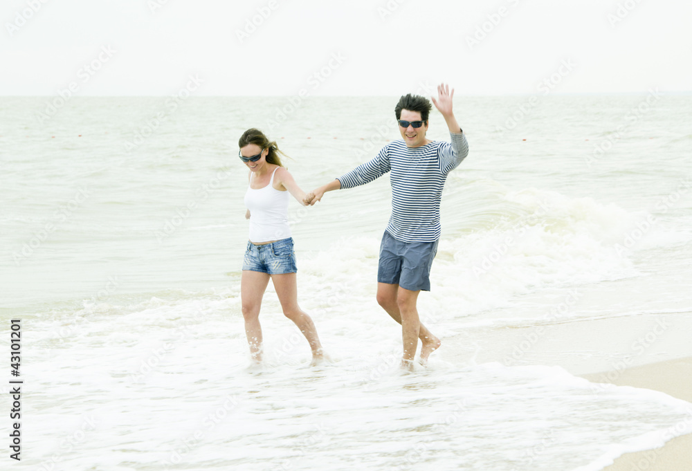 Happy couple enjoying together at the beach
