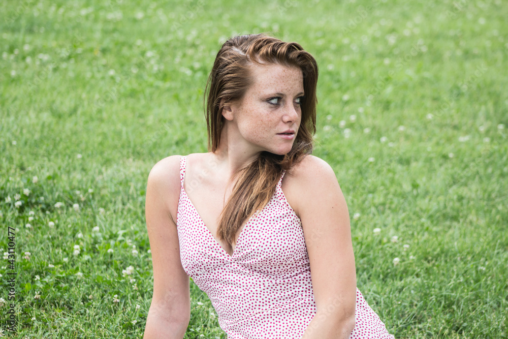Beautiful girl with red hair, relaxing at campus