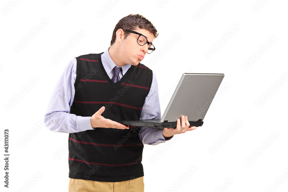 Young adult man giving a kiss and looking at a laptop computer Young adult man giving a kiss and looking at a laptop computer