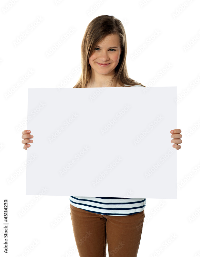Smiling teenager showing blank white billboard Smiling teenager showing blank white billboard