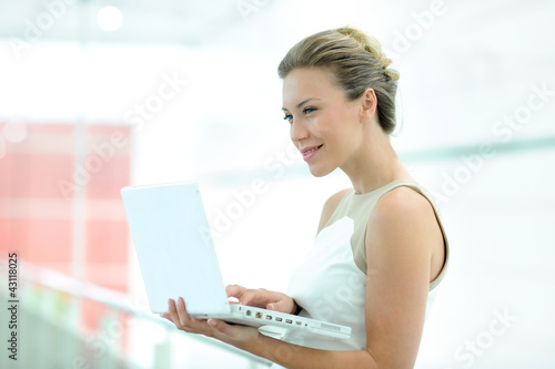 Beautiful corporate woman working on laptop