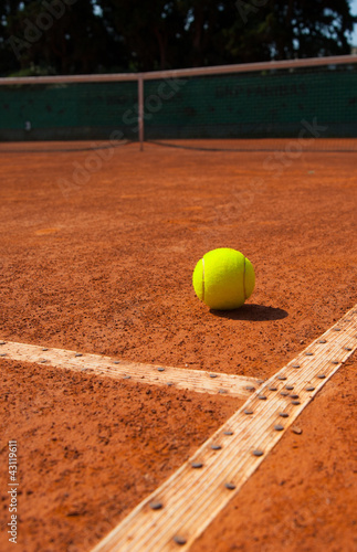 Tennis ball on clay court © mariosforsos