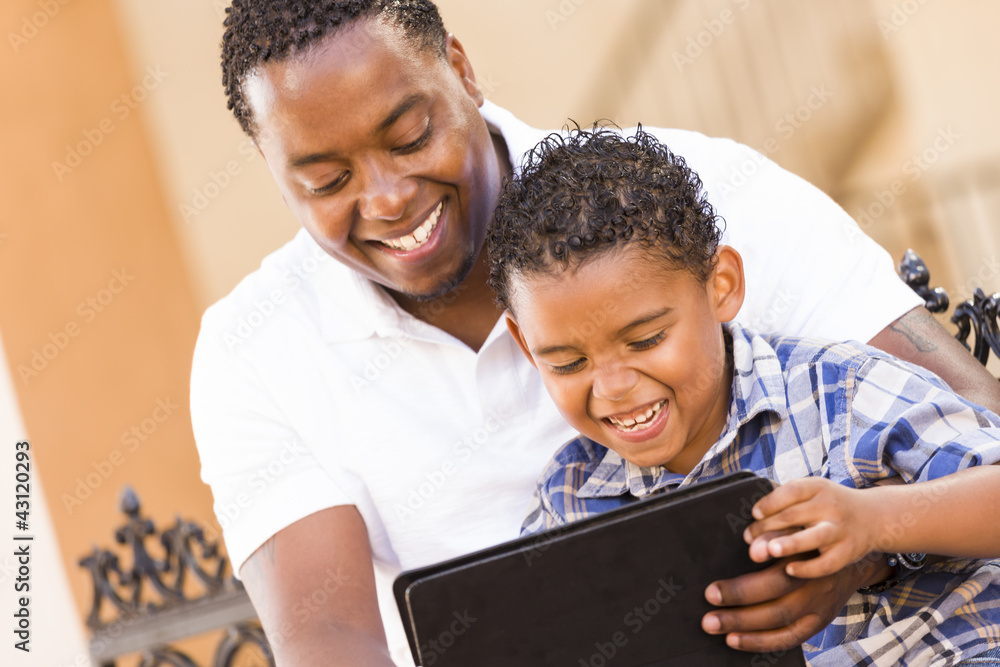Mixed Race Father and Son Using Touch Pad Computer Tablet Mixed Race Father and Son Using Touch Pad Computer Tablet