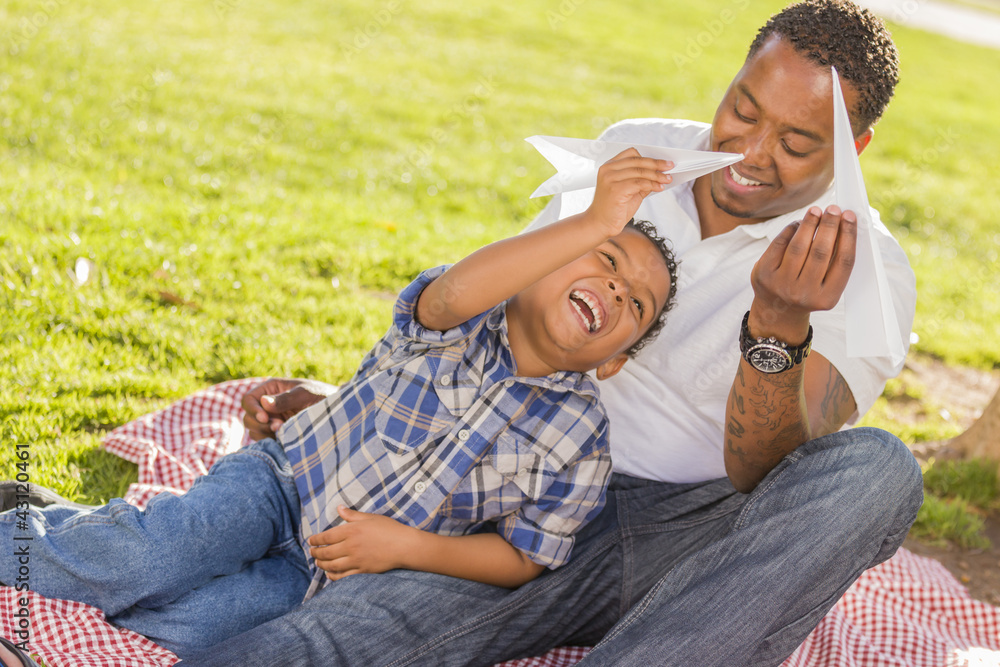 Fototapeta premium Mixed Race Father and Son Playing with Paper Airplanes