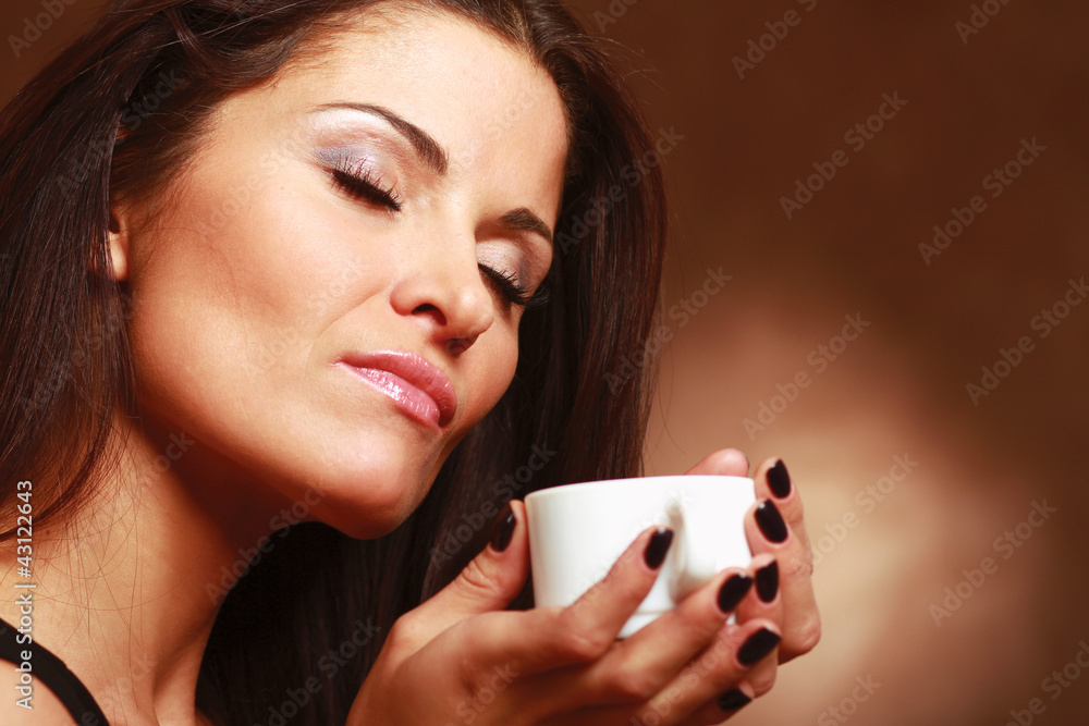 Woman with an aromatic coffee in hands Woman with an aromatic coffee in hands