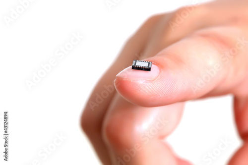 Computer microchip on girls fingernail